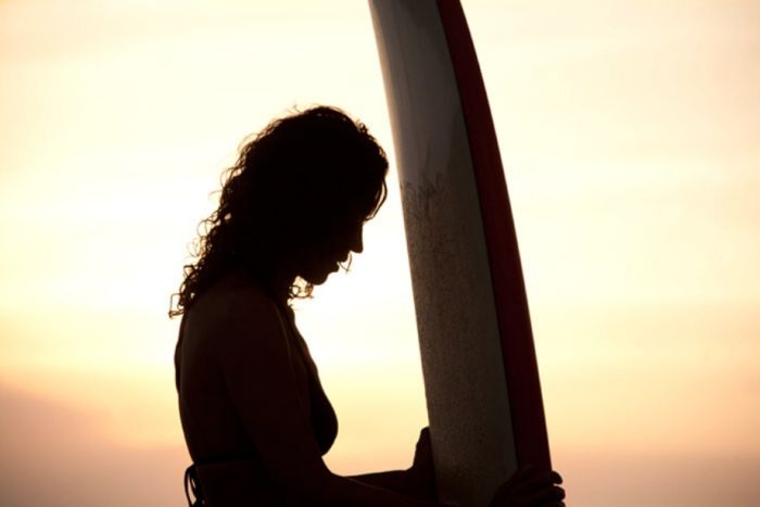 young surfing girl