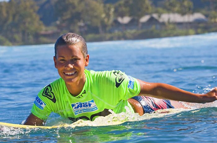 young surfing girl