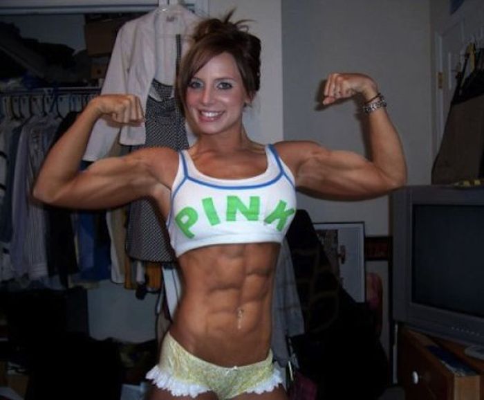 strong fitness bodybuilding girl with abdominal six-pack belly muscles