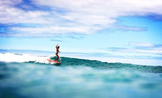 young surfing girl