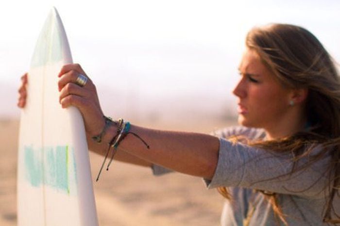 young surfing girl