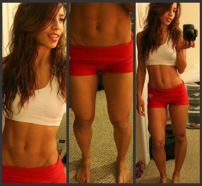 strong fitness bodybuilding girl with abdominal six-pack belly muscles