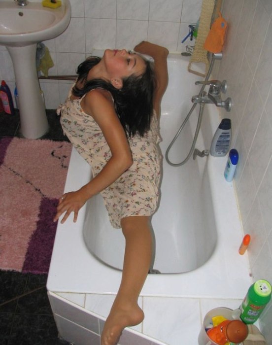 young brunette girl doing flexible gymnastics at home