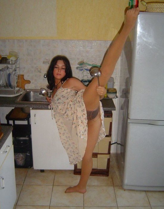 young brunette girl doing flexible gymnastics at home