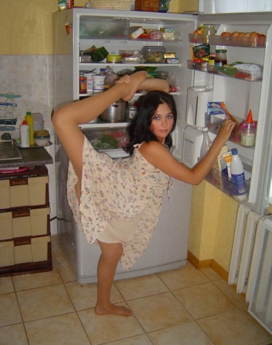 young brunette girl doing flexible gymnastics at home