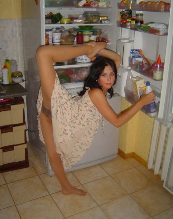 young brunette girl doing flexible gymnastics at home