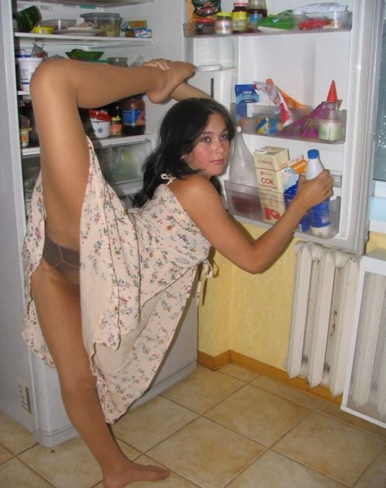 young brunette girl doing flexible gymnastics at home