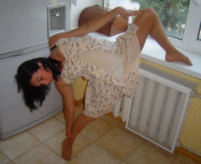 young brunette girl doing flexible gymnastics at home