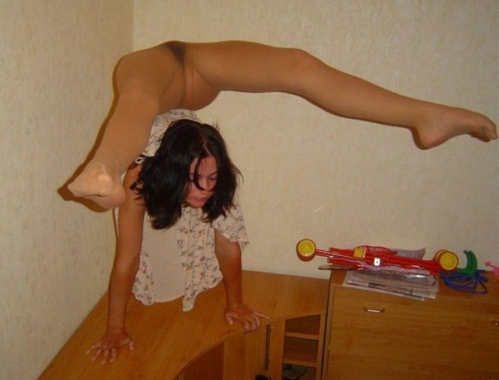 young brunette girl doing flexible gymnastics at home