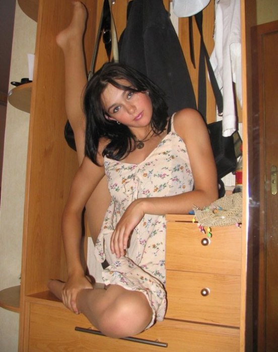 young brunette girl doing flexible gymnastics at home