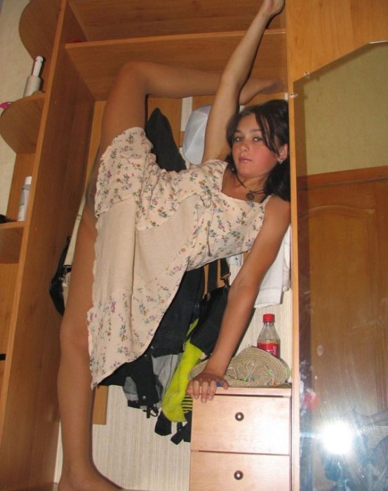 young brunette girl doing flexible gymnastics at home