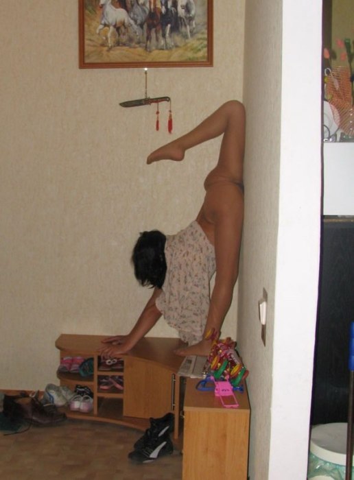 young brunette girl doing flexible gymnastics at home