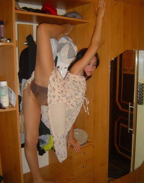 young brunette girl doing flexible gymnastics at home