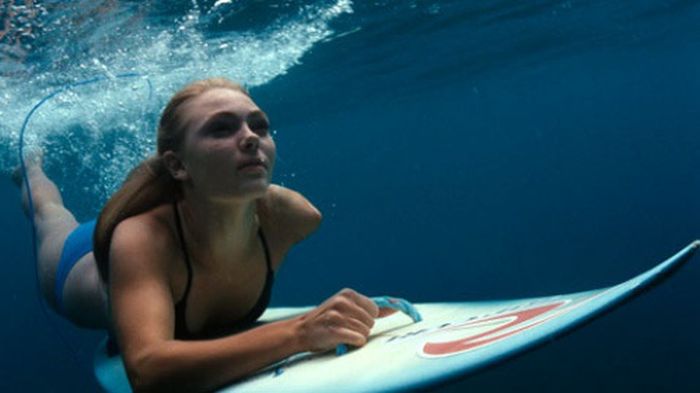 young surfing girl