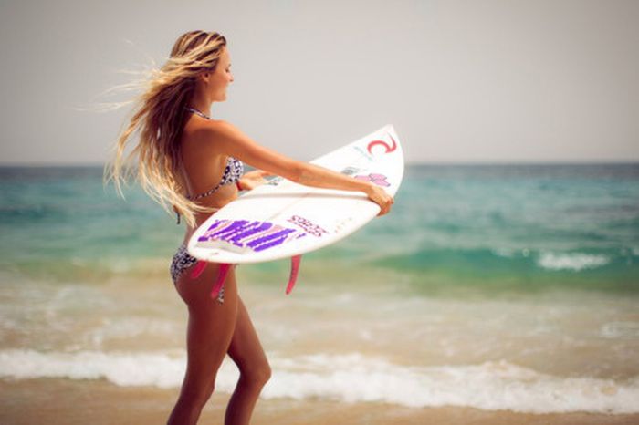 young surfing girl