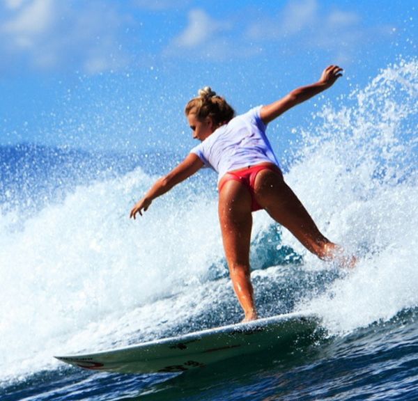 young surfing girl