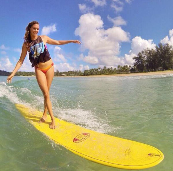 young surfing girl