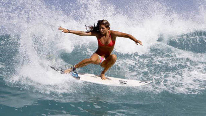 young surfing girl