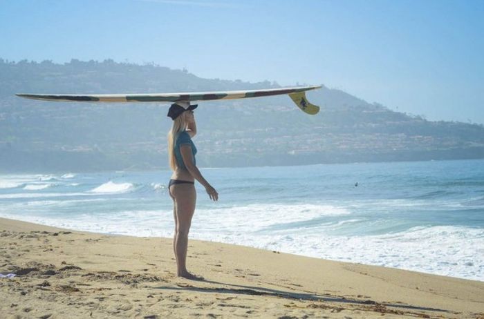 young surfing girl