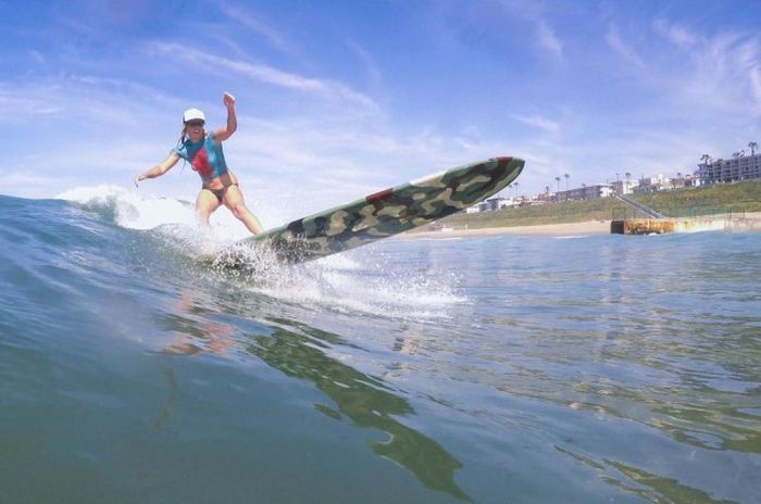 young surfing girl