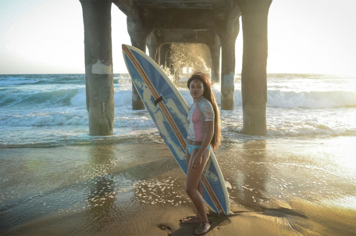 young surfing girl