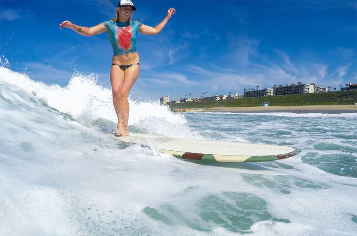 young surfing girl