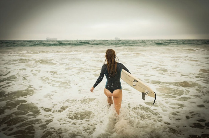 young surfing girl