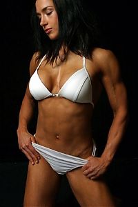 Sport and Fitness: strong fitness bodybuilding girl with abdominal six-pack belly muscles