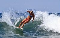 Sport and Fitness: young surfing girl