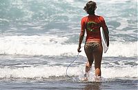 Sport and Fitness: young surfing girl