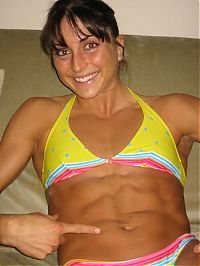 Sport and Fitness: strong fitness bodybuilding girl with abdominal six-pack belly muscles