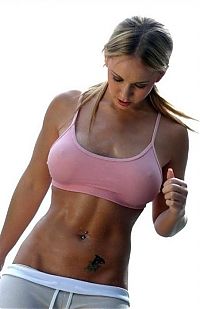 Sport and Fitness: strong fitness bodybuilding girl with abdominal six-pack belly muscles