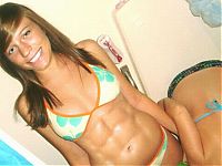 Sport and Fitness: strong fitness bodybuilding girl with abdominal six-pack belly muscles
