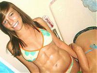 Sport and Fitness: strong fitness bodybuilding girl with abdominal six-pack belly muscles