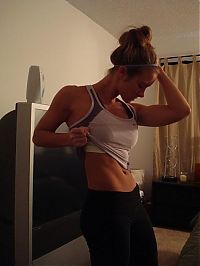 Sport and Fitness: strong fitness bodybuilding girl with abdominal six-pack belly muscles