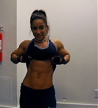 Sport and Fitness: strong fitness bodybuilding girl with abdominal six-pack belly muscles