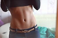 Sport and Fitness: strong fitness bodybuilding girl with abdominal six-pack belly muscles