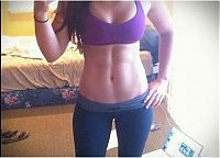 Sport and Fitness: strong fitness bodybuilding girl with abdominal six-pack belly muscles