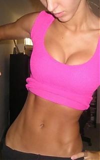 Sport and Fitness: strong fitness bodybuilding girl with abdominal six-pack belly muscles