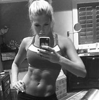 Sport and Fitness: strong fitness bodybuilding girl with abdominal six-pack belly muscles