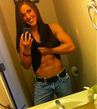 Sport and Fitness: strong fitness bodybuilding girl with abdominal six-pack belly muscles