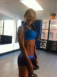 Sport and Fitness: strong fitness bodybuilding girl with abdominal six-pack belly muscles