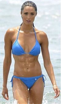 Sport and Fitness: strong fitness bodybuilding girl with abdominal six-pack belly muscles