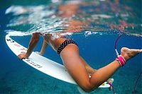 Sport and Fitness: young surfing girl