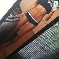 Sport and Fitness: strong fitness bodybuilding girl with abdominal six-pack belly muscles