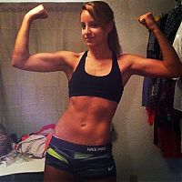 strong fitness bodybuilding girl with abdominal six-pack belly muscles