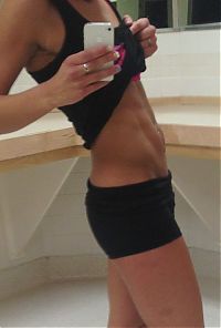 strong fitness bodybuilding girl with abdominal six-pack belly muscles