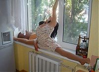 Sport and Fitness: young brunette girl doing flexible gymnastics at home