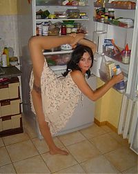 Sport and Fitness: young brunette girl doing flexible gymnastics at home