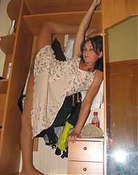 Sport and Fitness: young brunette girl doing flexible gymnastics at home